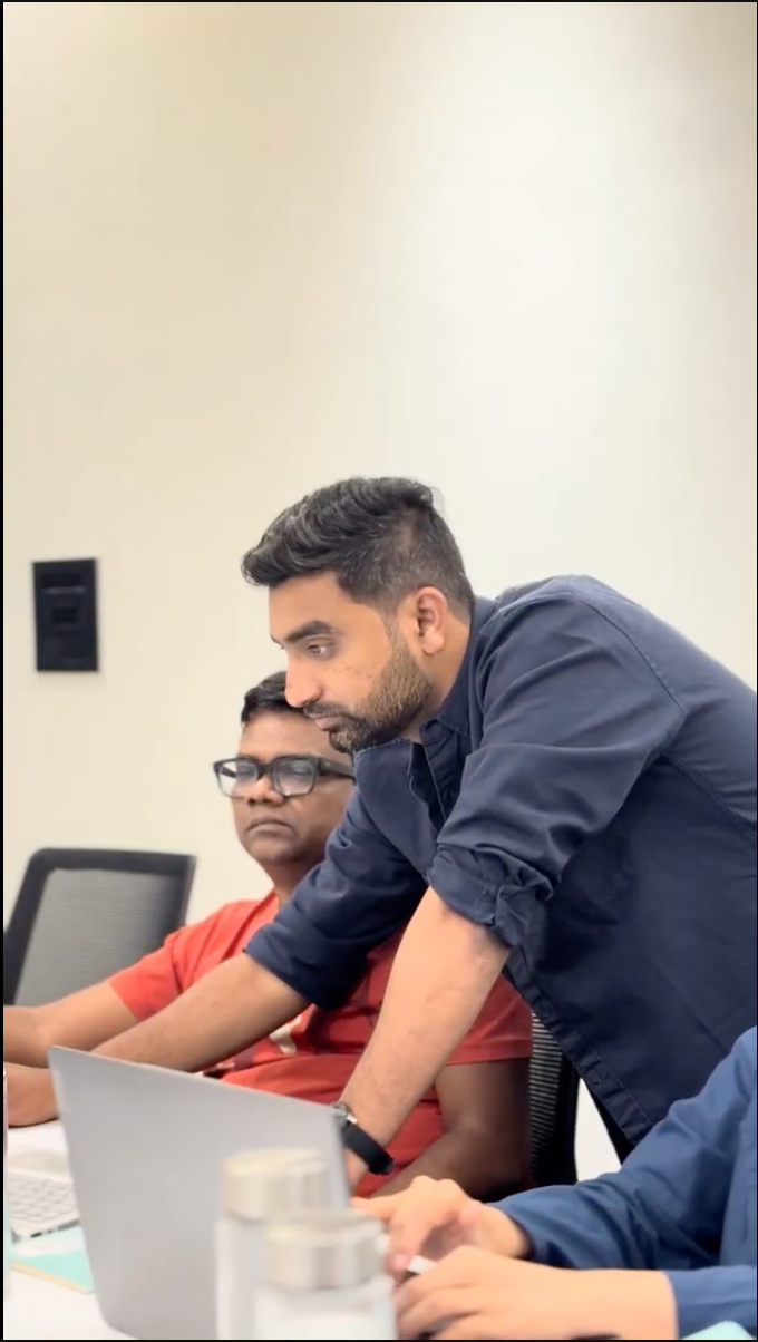 Giriraj reviewing a laptop screen with a participant beside him